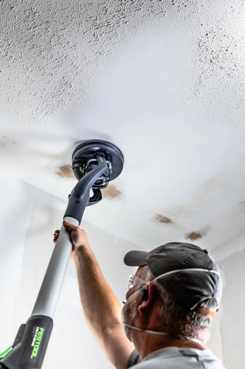 Professional painter using Festool dustless sanding technology