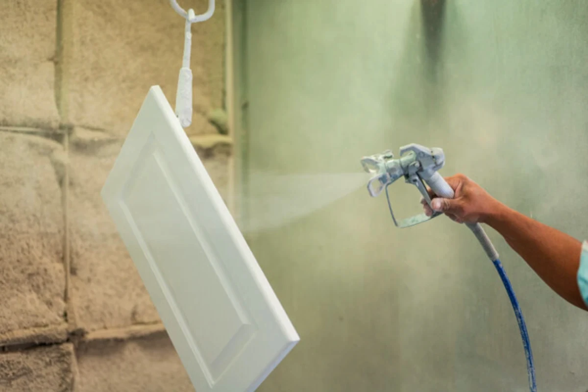 Professional cabinet refinishing process showing surface preparation
