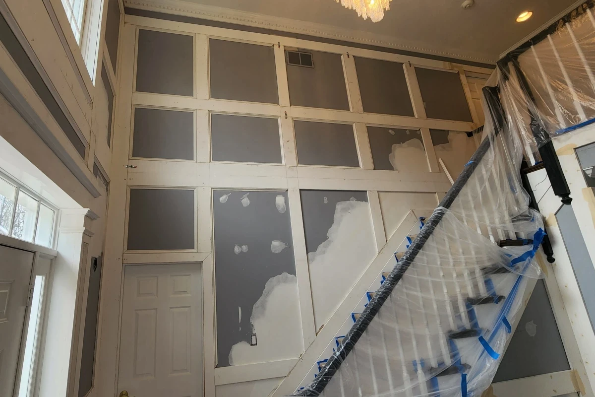Careful surface protection to prevent damage during drywall and trim work
