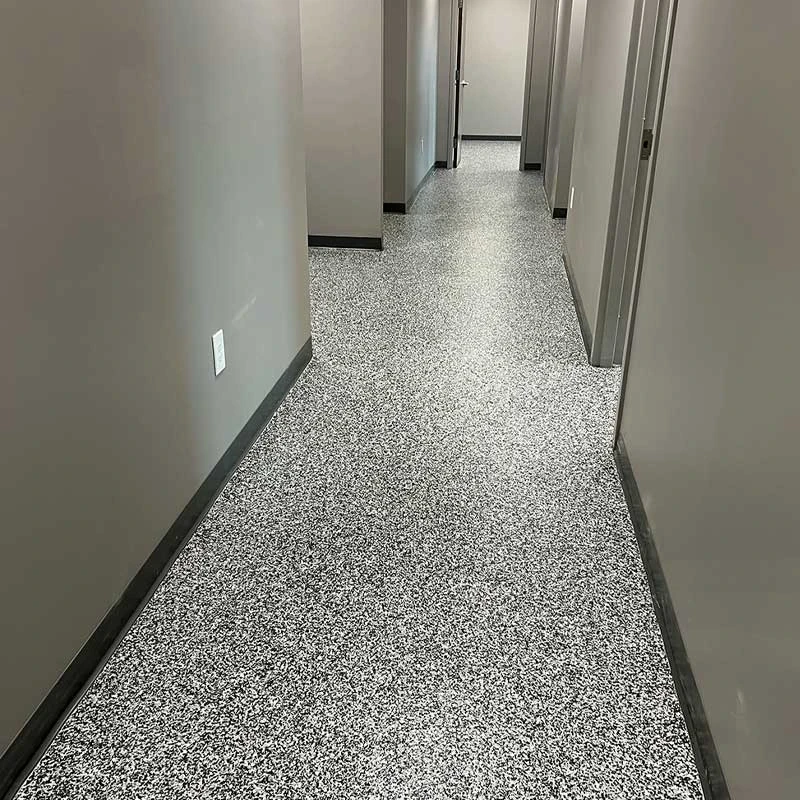 Commercial hallway with grey and black flake epoxy designed for heavy traffic