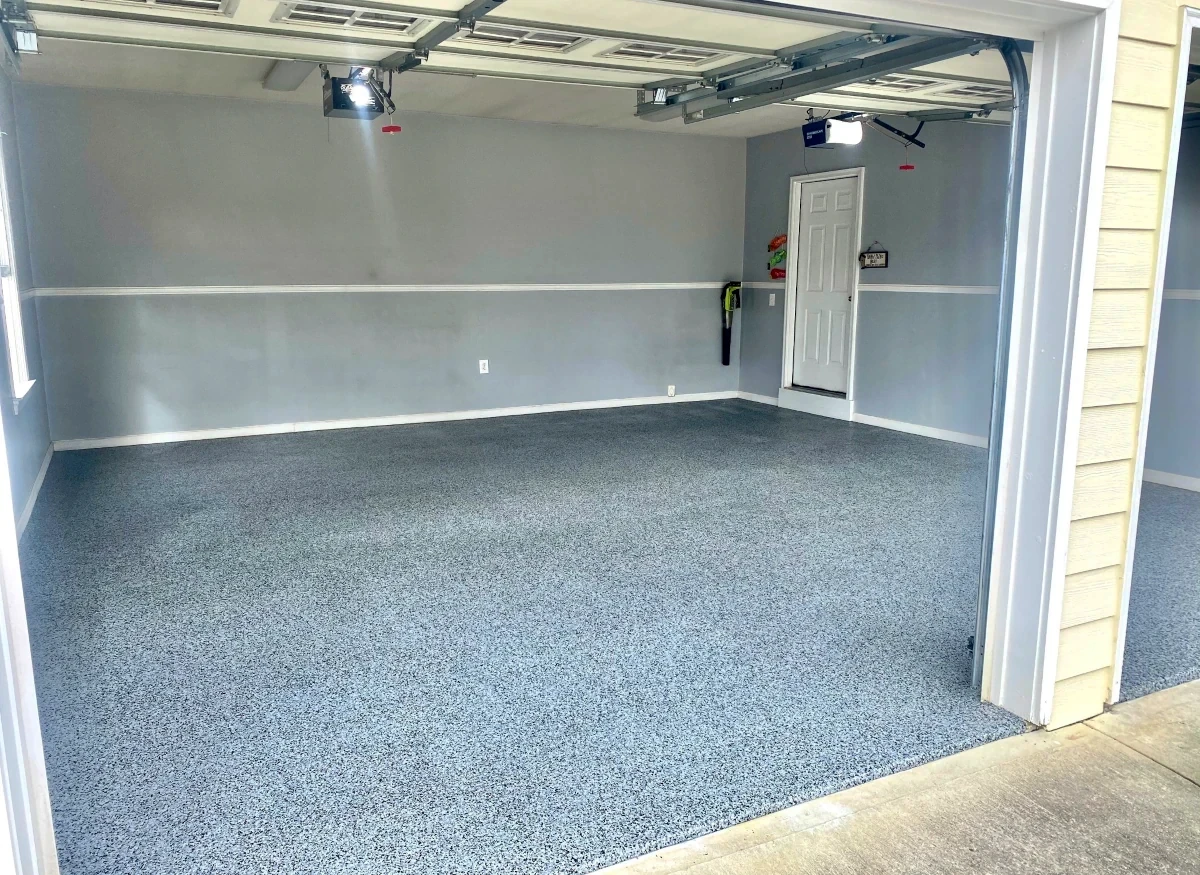 Garage with gray and black fleck epoxy floor installation
