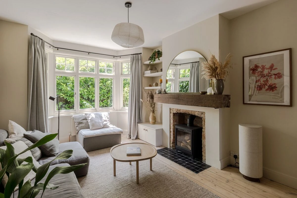 Elegant living room with fireplace and bay windows featuring perfect paint finish