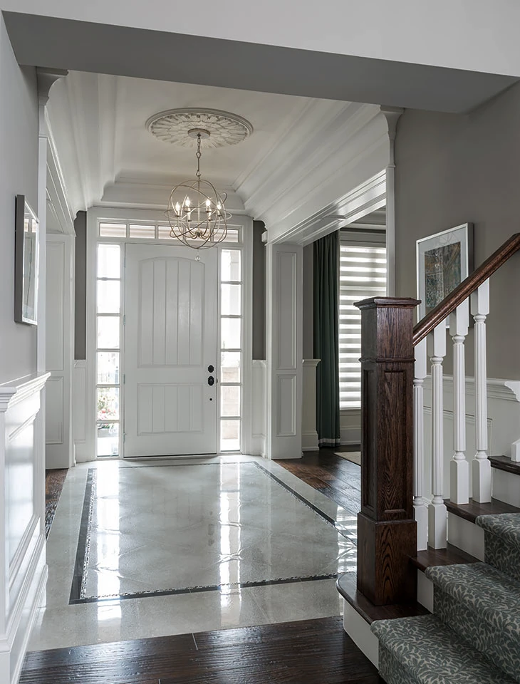 Elegant entryway with pristine white trim and contrasting wall colors
